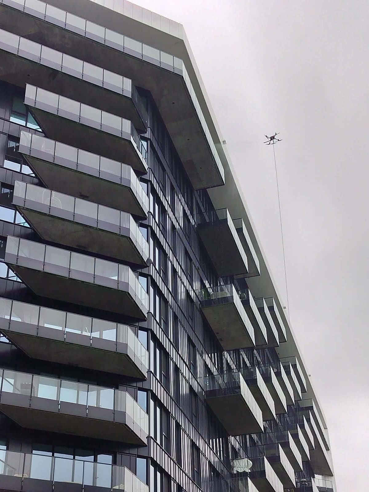 High-rise facade being cleaned by drone