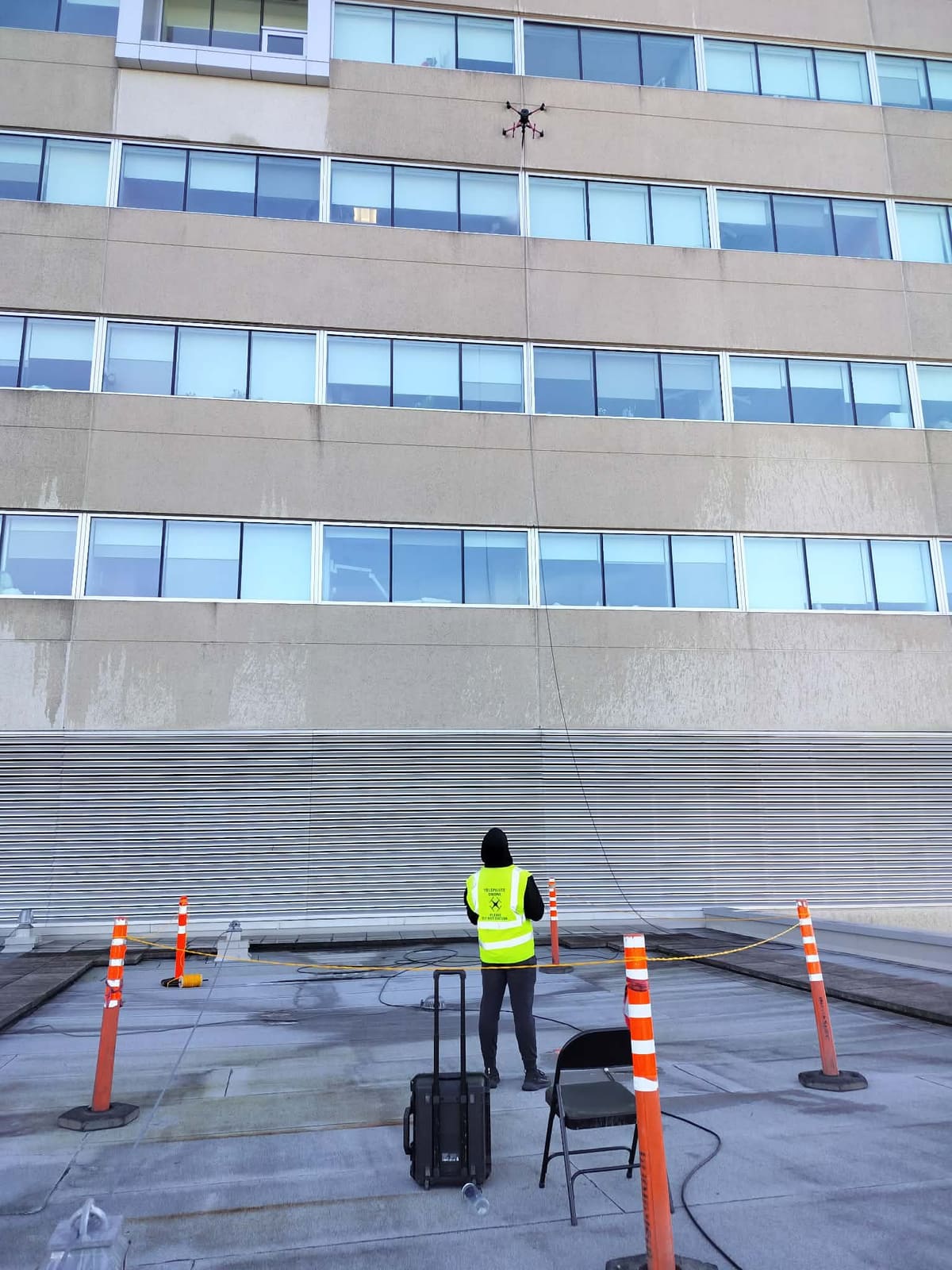 Operator running a drone cleaning job from the ground